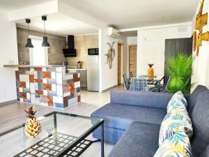 a living room with a blue couch and a table at Apartamentos Las Palmeras in Palmanova