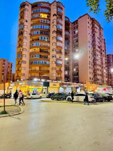 people walking in a parking lot in front of a large building at Bab ezzouar in Bab Ezzouar