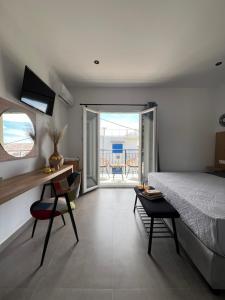 1 dormitorio con 1 cama, mesa y sillas en Cactus, en Skiathos