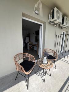 two chairs and a table on a balcony at Cactus in Skiathos