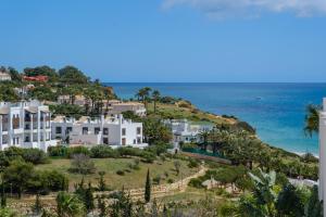 an aerial view of a house on a hill next to the ocean at Porto de Mos 69 by Destination Algarve in Porto de Mós