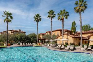 a swimming pool at a resort with palm trees at Marriott's Newport Coast Villas in Newport Beach