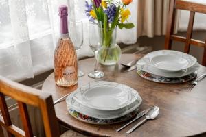 a table with two plates and a bottle of wine at Deco Studio: King bed, kitchenette, stylish & comfortable in Brighton & Hove