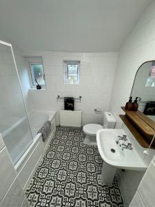 a bathroom with a sink and a toilet and a shower at 3-Bed House, Birmingham in Birmingham