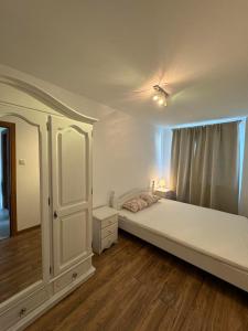 a bedroom with a large white bed and a window at Mieszkanko na Sopockiej polanie. in Sopot