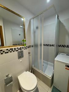 a bathroom with a toilet and a glass shower at Mieszkanko na Sopockiej polanie. in Sopot