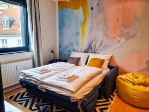 uma pequena cama num quarto com uma parede em maremar - City Design Apartment - Luxus Boxspringbetten - Highspeed WIFI - Arbeitsplätze em Braunschweig