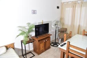 a living room with a tv on a wooden stand at Departamentos x dia Viedma CON COCHERA in Viedma