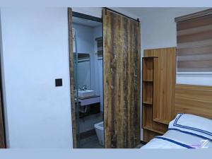 a bedroom with a mirror and a bed and a sink at Ujuuu apartments in Lekki