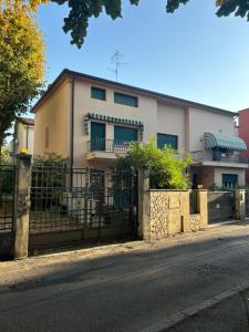 una casa blanca con una valla delante en Villetta centro Imola 4 persone in matrimoniale, una piazza e mezzo e un singolo con parcheggio privato gratuito, en Imola
