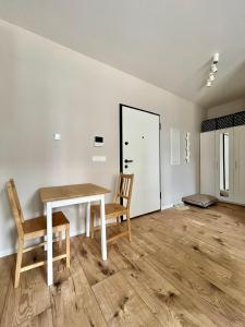 a dining room with a table and two chairs at M&M Doki Studio in Gdańsk