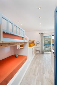 a bedroom with bunk beds and a balcony at Bella Vista Mare in Moutsouna Naxos