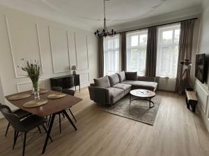 a living room with a couch and a table at Apartament No. 5 City Center in Świdnica