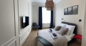 a bedroom with a bed and a television in it at Apartament No. 5 City Center in Świdnica