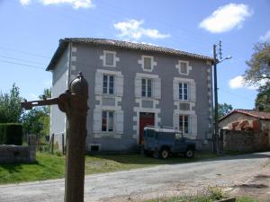 a house with a fire hydrant in front of it at La Maison Bleue in Exideuil
