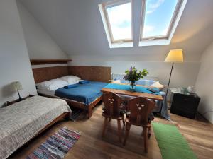 a bedroom with a bed and a desk with a table at Oberża Pod Kudłatym Aniołem in Cisna