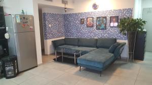 a living room with a couch and a refrigerator at Dream house in Eilat +11 photos