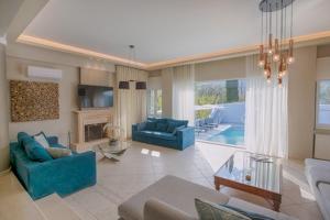 a living room with two blue couches and a fireplace at Boat Villa in Yenion