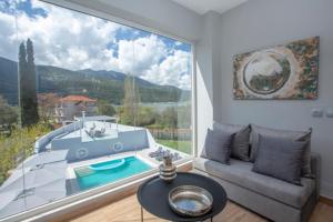 a living room with a large window and a couch at Boat Villa in Yenion