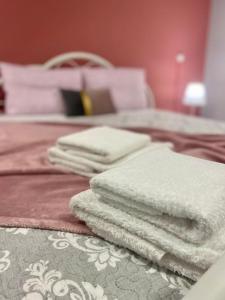 a pile of towels sitting on top of a bed at Cozy apartment near to the airport in Kouvarás