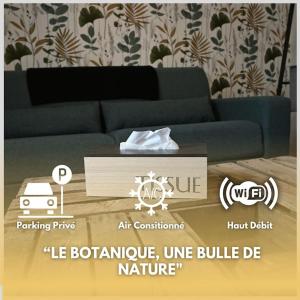 a living room with a couch and a table at Le Botanique Centre Clim WIFI in Châteauroux