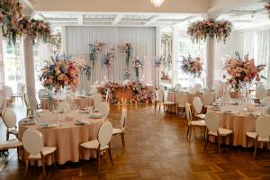 a banquet hall with tables and chairs and flowers at Hotel Toscania in Włoszakowice