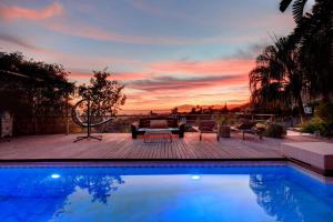 a swimming pool with a sunset in the background at Marbella Boutique Art suites in Marbella