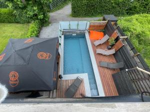 an overhead view of a swimming pool with an umbrella at La Suite Diamant in Theux