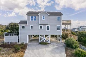 a large white house with a porch at Azure home in Emerald Isle