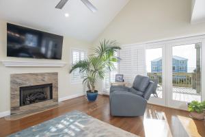 a living room with a chair and a fireplace at Azure home in Emerald Isle