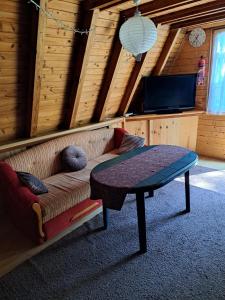 a living room with a couch and a table at Domek Ostrowo in Ostrowo