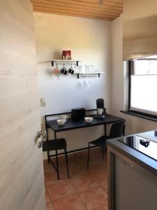 a kitchen with a table in the corner of a room at Apartment Leuchtberg Flair Eschwege in Eschwege