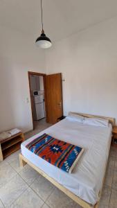 a large bed in a room with a kitchen at Kofinaki apartment 2 - Tychero Evros in Tycherón