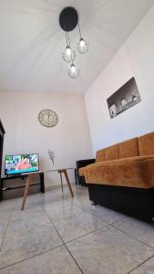 a living room with a couch and a tv at Kofinaki apartment 2 in Tycherón