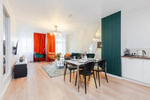 a kitchen and dining room with a table and chairs at VIDOC APARTMENTS in Warsaw