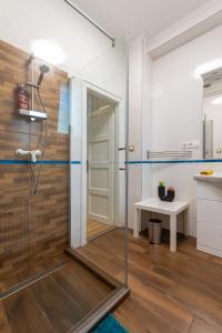 a glass shower in a bathroom with a table at B12 Apartment Budapest in Budapest