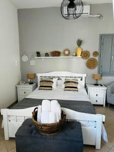 una camera da letto con un grande letto bianco e una sedia di Mare Nostrum Santo a Oia Altre 37 foto