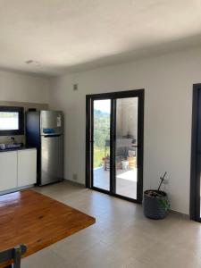 a living room with a door open to a patio at Casal Sur in Potrero de Garay +10 photos