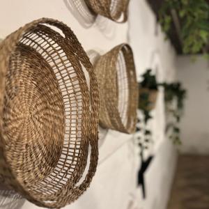 a group of baskets hanging on a wall at Hotell Gillet i Köping in Köping