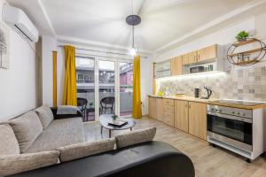 a living room with a couch and a kitchen at Apartments Lido in Ohrid