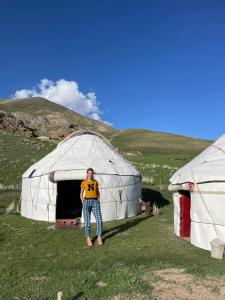 a man standing in front of a yurt at Guest House Bereke in Kyzart village in Bagysh