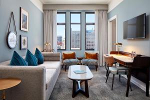 a living room with a couch and a table at The Citizen Hotel, Autograph Collection in Sacramento