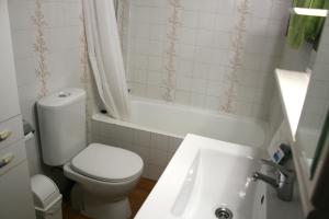 a bathroom with a toilet and a sink and a tub at Apartamento en primera linea de mar en Pals 306-1 2H in Pals +16 photos