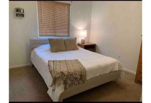 a bedroom with a large bed with a window at Lovely 2- Bedroom Duplex in Pueblo West in Pueblo West
