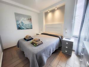 a bedroom with a bed with two towels on it at playa honda in Playa de las Americas