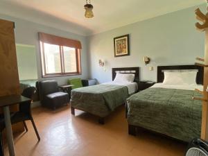Postel nebo postele na pokoji v ubytování Hotel Tinkus Inn