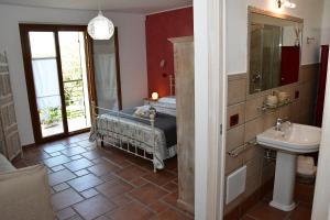 a bathroom with a bed and a sink in a room at Colle degli ulivi Green Resort in Petacciato +43 photos