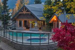 a house with a pool in front of it at Cozy Townhouse in Whistler Village North in Whistler