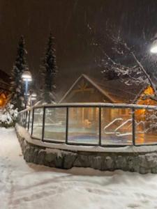 a building covered in snow at night at Cozy Townhouse in Whistler Village North in Whistler