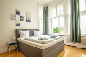 a bed in a room with a large window at K132 bis 10 Personen 155 sqm 3 Bedrooms 2 Bathrooms 2OG Aufzug 2 Balkone Boxspringbetten in Berlin
